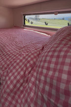 Blush Retreat 300TC pink gingham zip caravan bunk bedding set inside caravan with ocean view